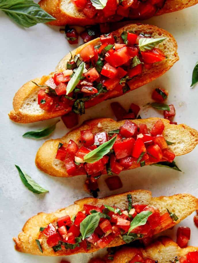 Bruschetta on toasted baguettes with basil. 