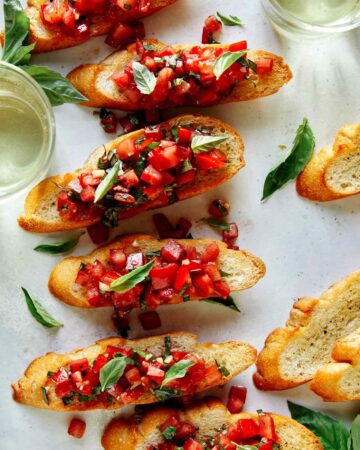 Bruschetta on toasted baguette with wine on the side.