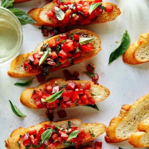 Bruschetta on toasted baguette with wine on the side.