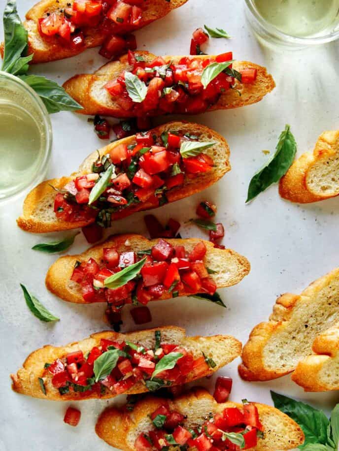 Bruschetta on toasted baguette with wine on the side.