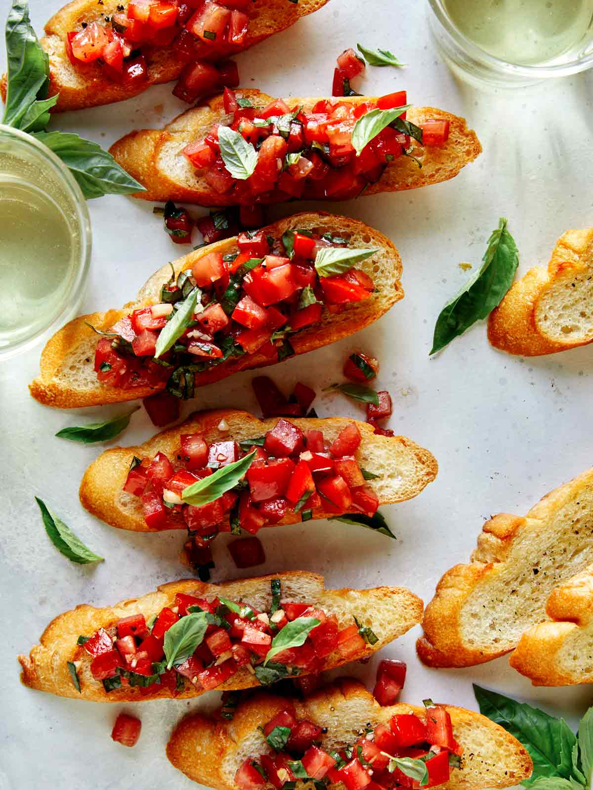 Bruschetta on toasted baguette with wine on the side. 