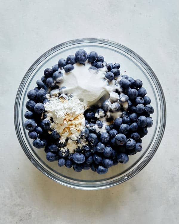 Blueberry cobbler ingredients in a bowl ready to be mixed together.