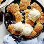 Blueberry cobbler recipe with a scoop taken out.