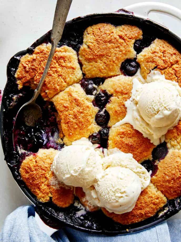 Blueberry cobbler recipe with a scoop taken out.