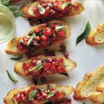 Bruschetta on toasted baguette with wine on the side.