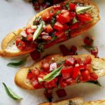 Bruschetta recipe on toasted crostini close up.