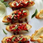 Bruschetta on toasted baguette with wine on the side.