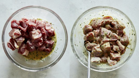 Lamb shoulder cubes in a bowl with marinade.