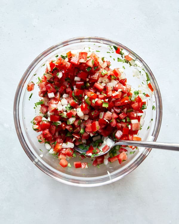 Pico de gallo in a bowl mixed together.