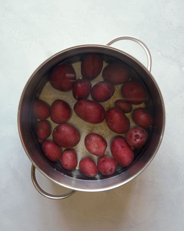 Red potatoes in a pot boiling. 