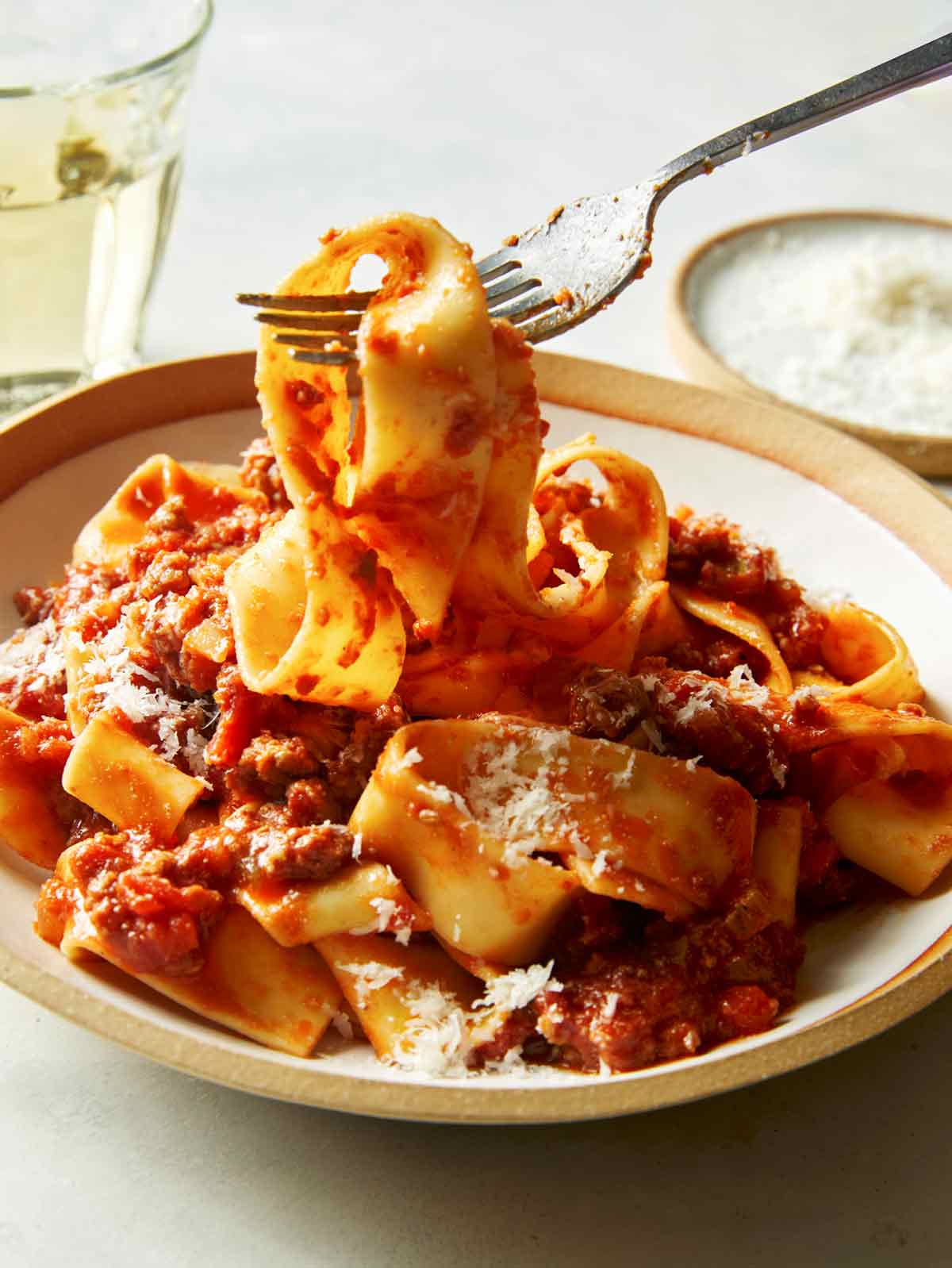 Bolognese sauce with pasta and a fork in a bowl.