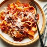 Bolognese sauce with parmesan and pasta in a bowl.