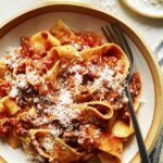 Bolognese sauce recipe in a bowl with parmesan.