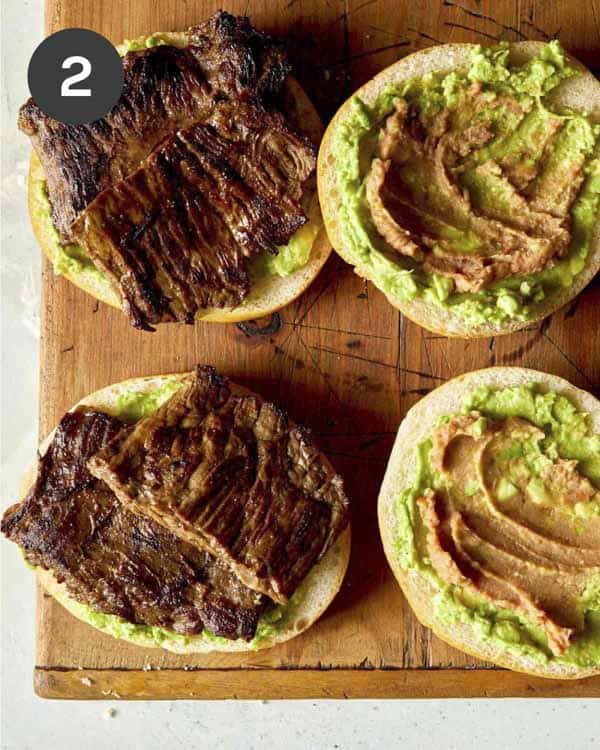 Carne asada being added to rolls to make a torta.