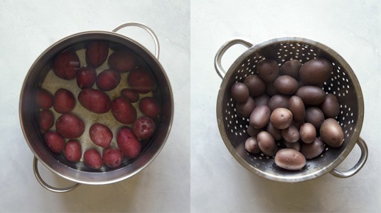 Red potatoes in a pot boiling.