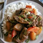 Galbi jjim recipe served onto a plate with rice.