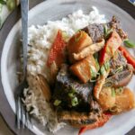 Galbi jjim recipe served onto a plate with rice.