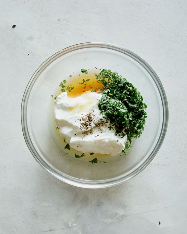 Mint yogurt sauce for lamb kabobs in a bowl.