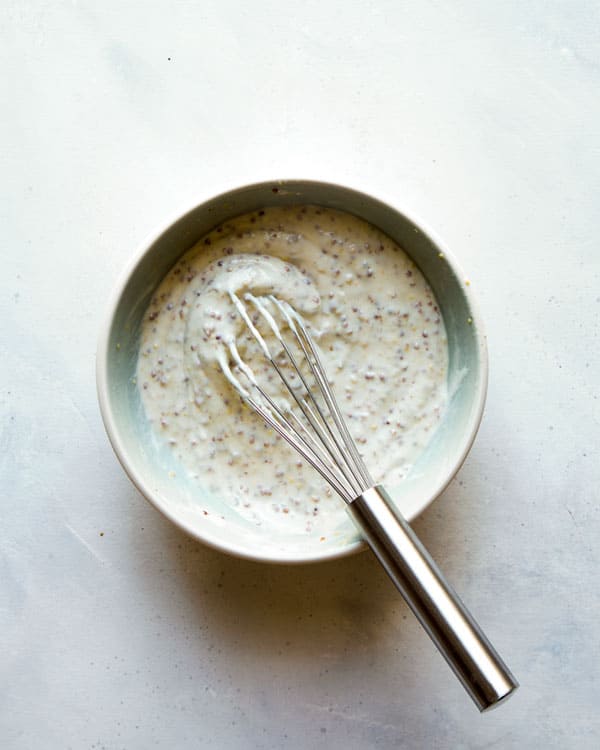 Potato salad dressing in a bowl whisked together. 