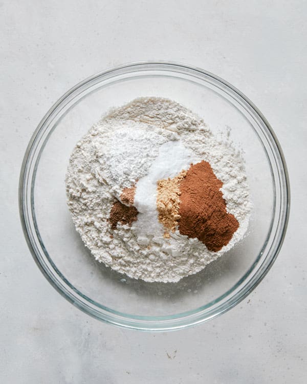 Dry ingredients in a glass bowl to make pumpkin bars.