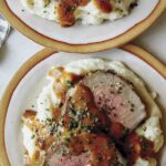 Easy Roast beef recipe plated with gravy and mashed potatoes.