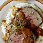 Easy Roast beef recipe plated with gravy and mashed potatoes.