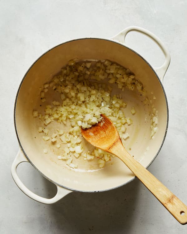 Cooking onions in a stock pot to make arrabiata sauce. 