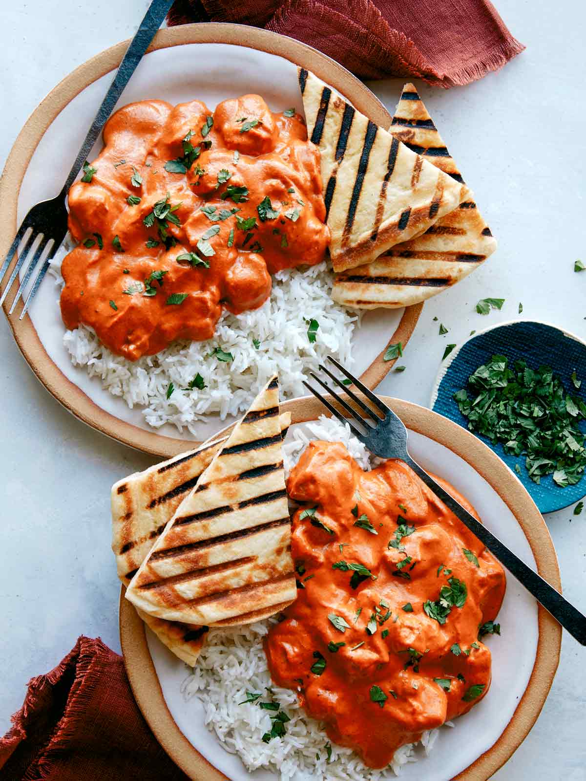 Murgh makhani, or butter chicken recipe made and served on two plates.
