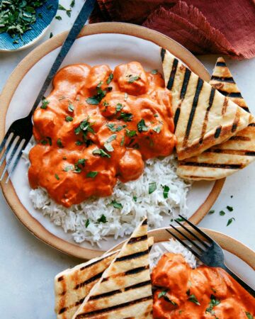 Butter chicken, or murgh makhani recipe on two plates with rice.