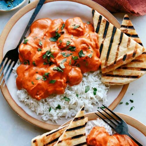 Butter chicken, or murgh makhani recipe on two plates with rice.