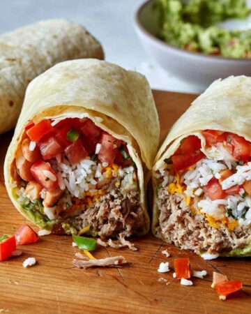 Carnitas burrito recipe cut in half.