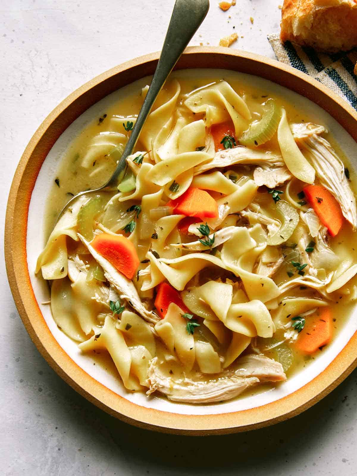 Close up on a bowl of chicken noodle soup. 