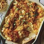 Creamy cauliflower bake recipe in a dish with some served onto a plate.