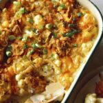 Baked cauliflower recipe in a baking dish with a scoop out.