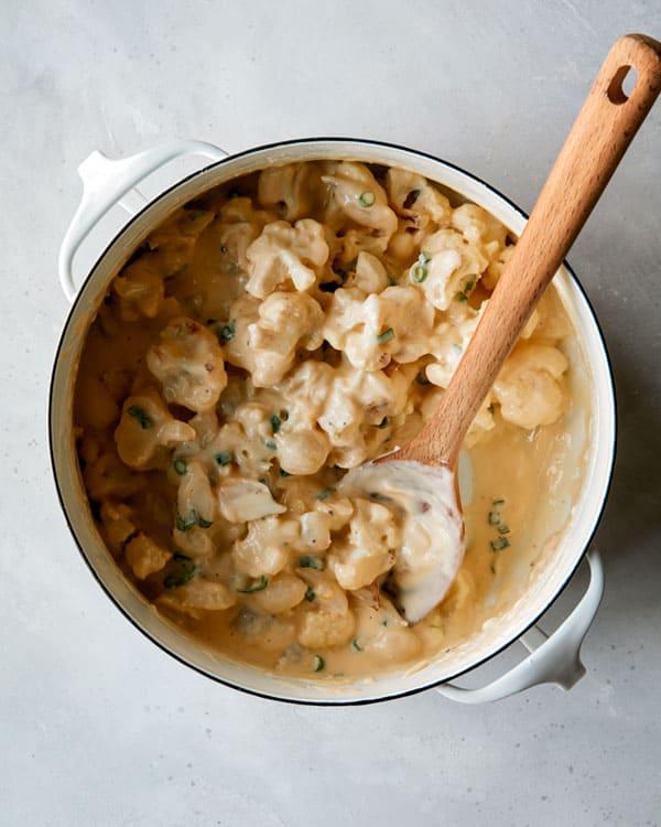 Cauliflower with a cheese sauce in a pot.