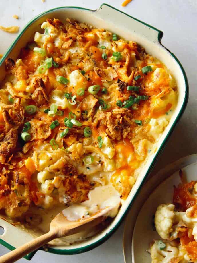 Baked cauliflower recipe in a baking dish with a scoop out. 