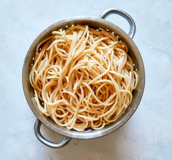 Cooked pasta in a colander.