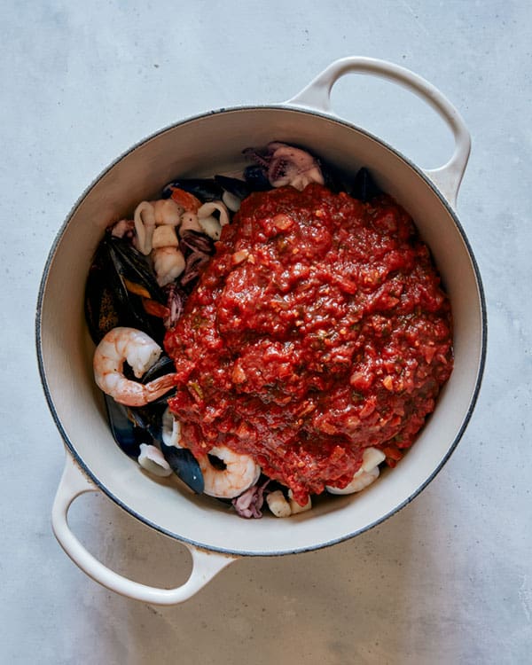 Frutti di mare in a pot about to be stirred together. 
