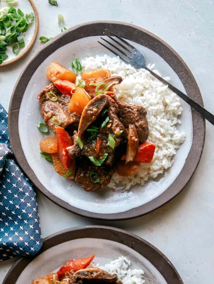 Galbi jjim recipe served onto two plates.