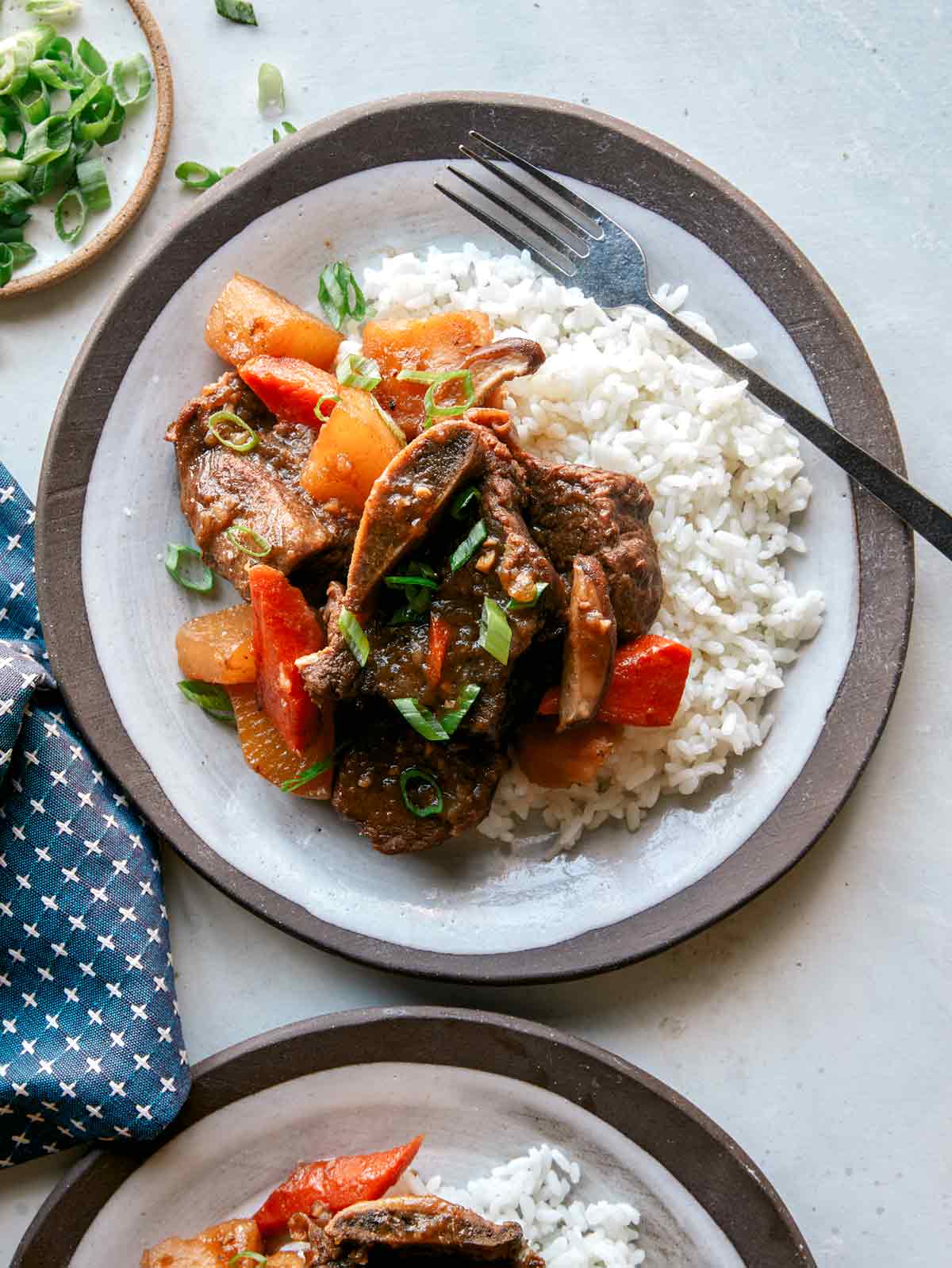 Galbi jjim recipe served onto two plates.