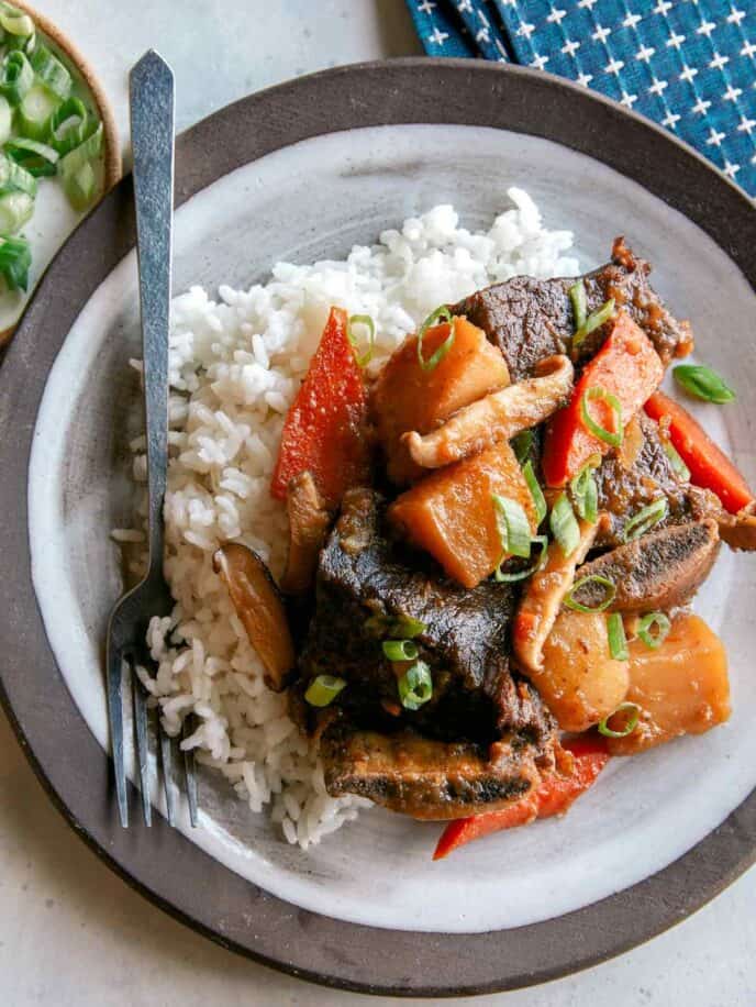 Galbi jjim recipe served onto a plate with rice. 