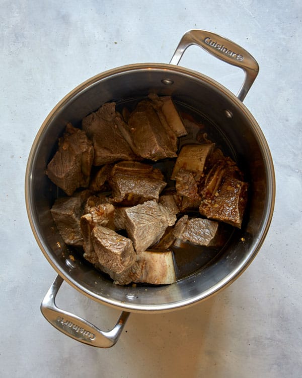 Short ribs in a pot mixed with braising liquid to make Galbi Jjim.