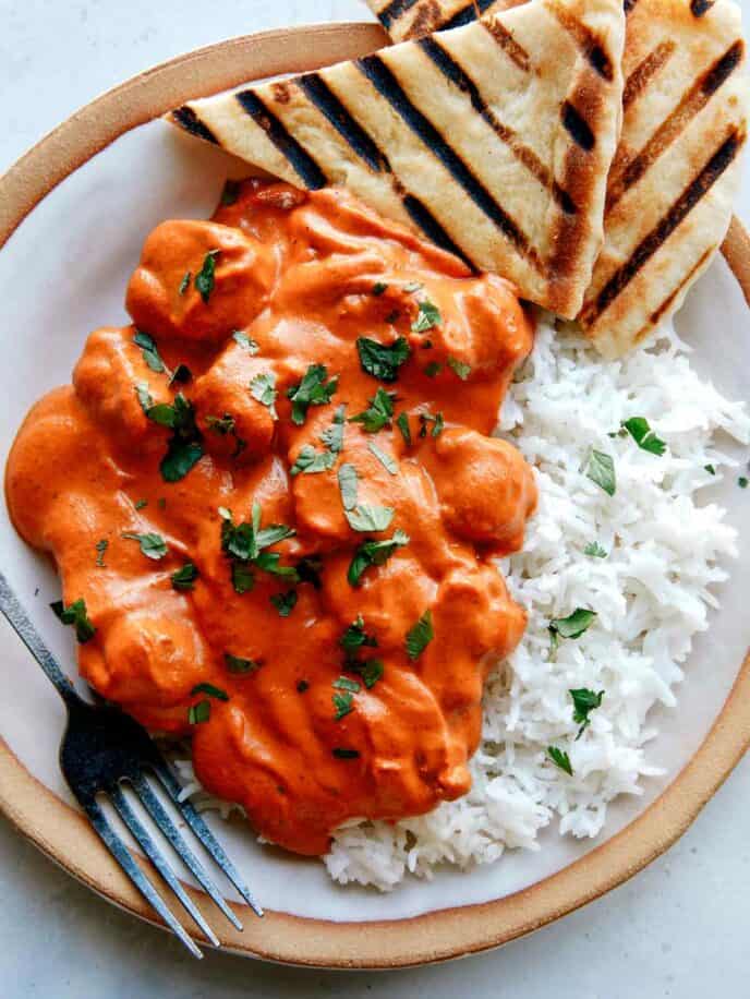 Butter Chicken recipe on a plate with rice. 