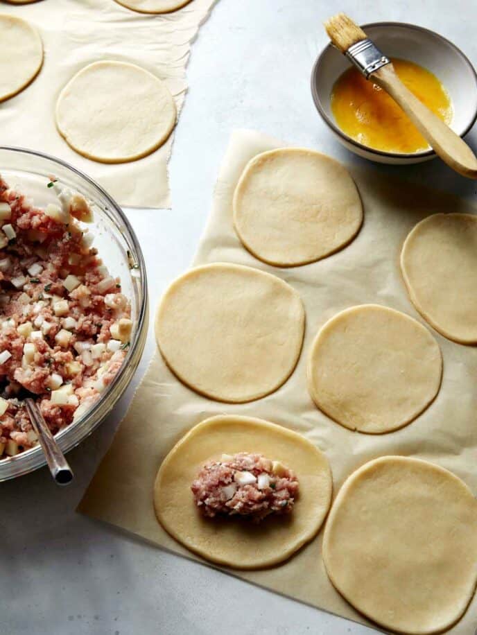 Making pork pasties by filling dough. 