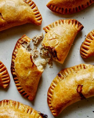 Pork pastie recipe with one torn open.