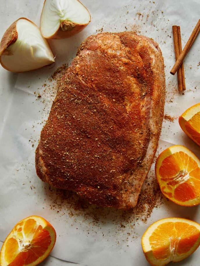 Pork shoulder rubbed with spices to make carnitas.