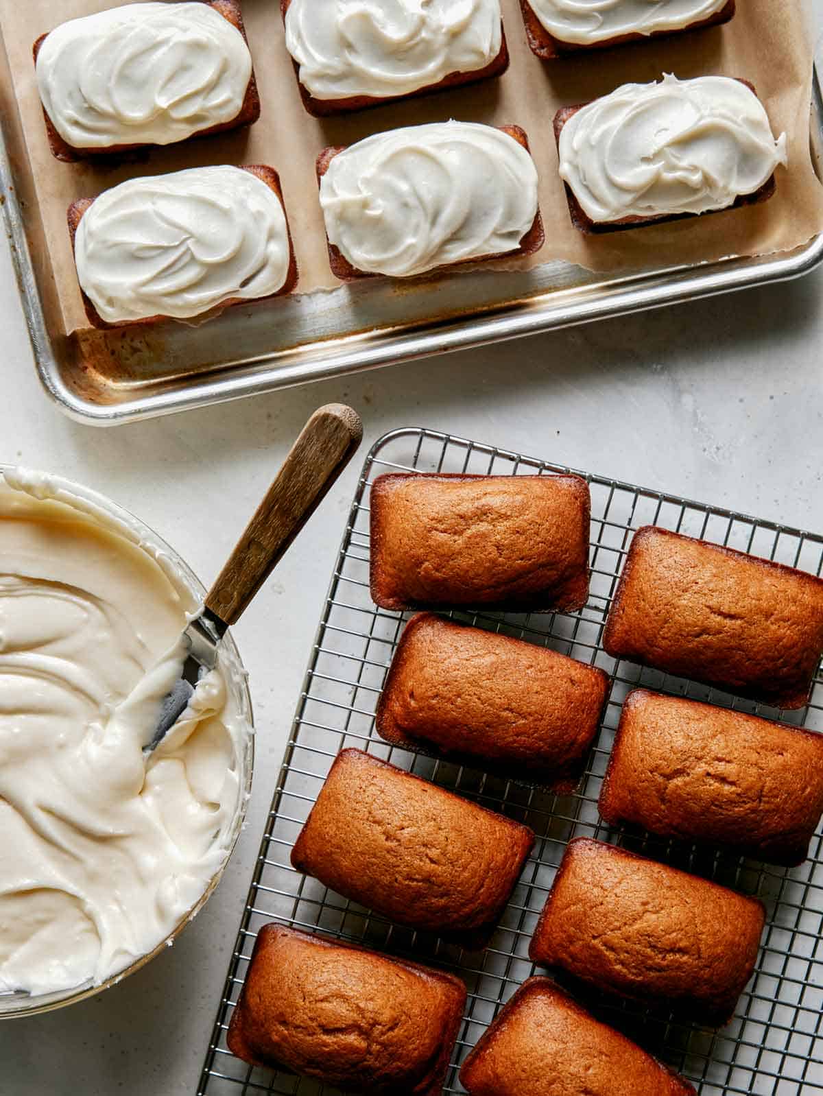 Pumpkin bars being topped with cream cheese frosting. 