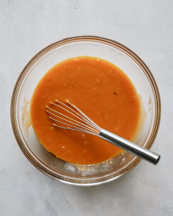 Wet ingredients whisked together to make pumpkin bars recipe.
