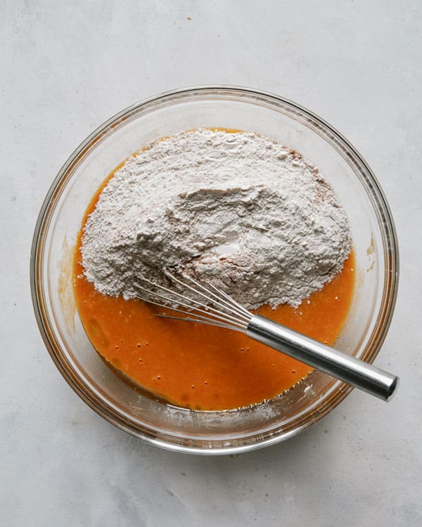 Combining dry and wet ingredients to make the batter for pumpkin bars.