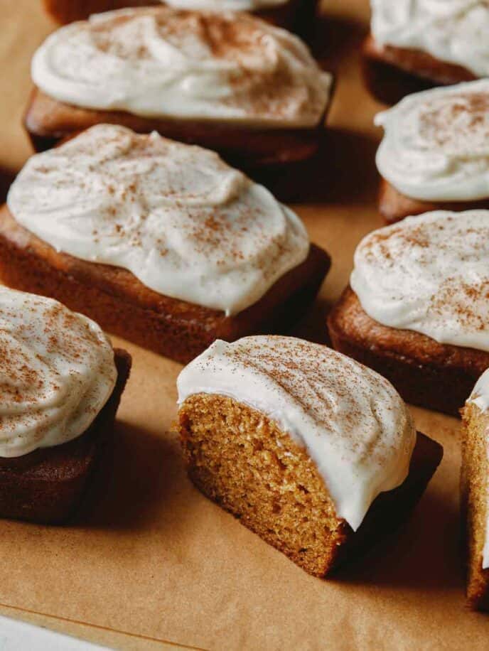 Pumpkin Bars with one cut in half on parchment.
